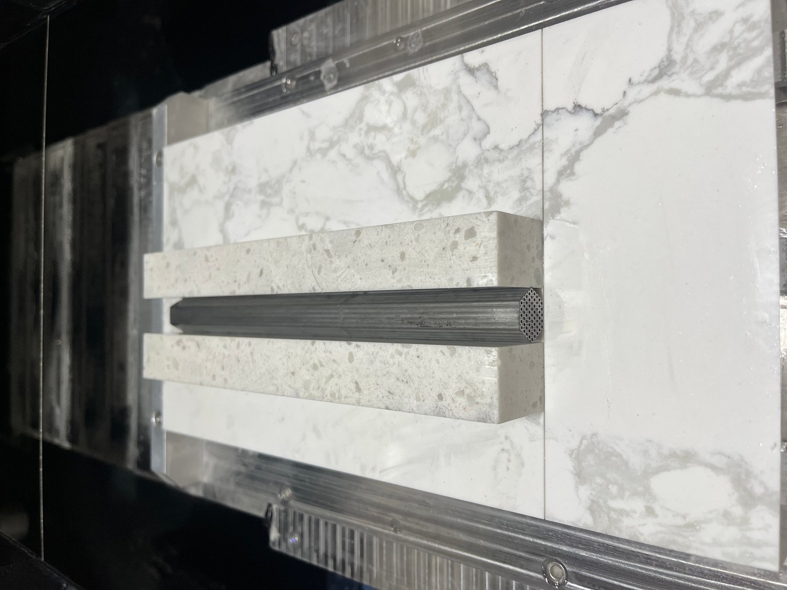 Metal tube clamped on the cutting platform during the diamond wire loop saw process